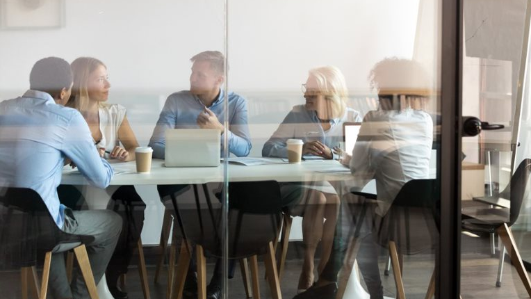 A group of people having a meeting in a boardroom